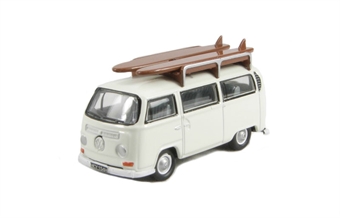 VW Bus with surfboards on roof in Pastel white