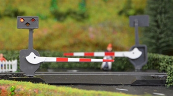 Pair of modern level crossing barriers with lights and sound