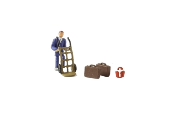 Station porter with hand truck and luggage